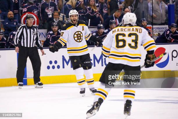 Patrice Bergeron of the Boston Bruins reacts after scoring a power play goal against the Columbus Blue Jackets during the first period in Game Four...