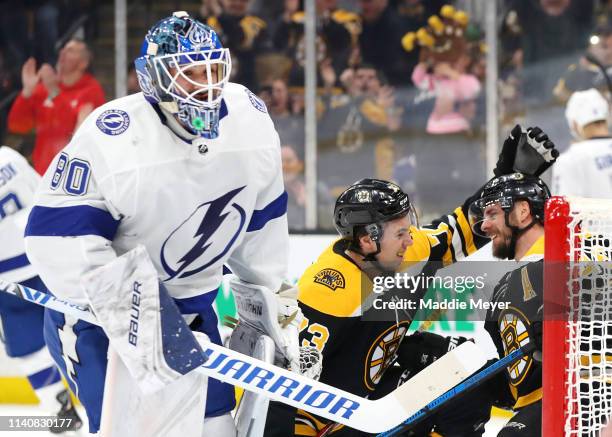 David Krejci of the Boston Bruins celebrates with Charlie McAvoy after scoring a goal against the Tampa Bay Lightning during the first period at TD...