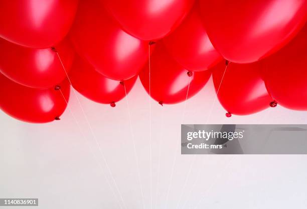 red balloons - red balloons stock pictures, royalty-free photos & images