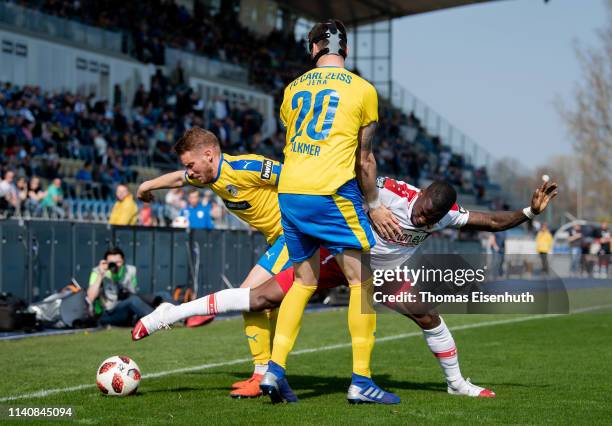 Florian Bruegmann of Jena is challenged by Streli Mamba of Cottbus during the 3. Liga match between FC Carl Zeiss Jena and FC Energie Cottbus at...