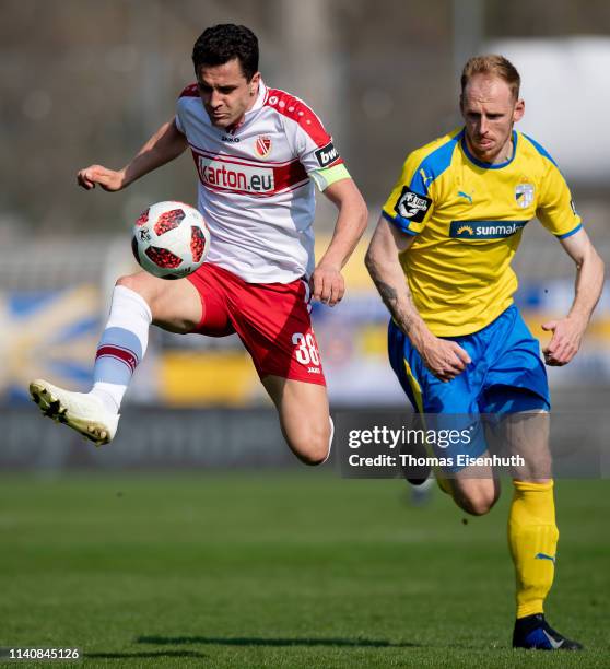 Justin Gerlach of Jena is challenged by Dimitar Rangelow of Cottbus during the 3. Liga match between FC Carl Zeiss Jena and FC Energie Cottbus at...