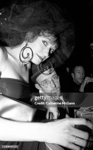 Ann Magnuson and Keith Haring at a party at Guignol's restaurant in April 1987 in New York City, New York.