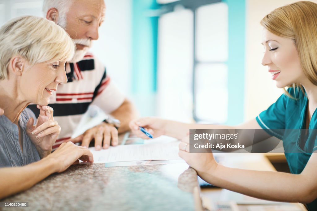 Senior couple making a doctor's appointment.