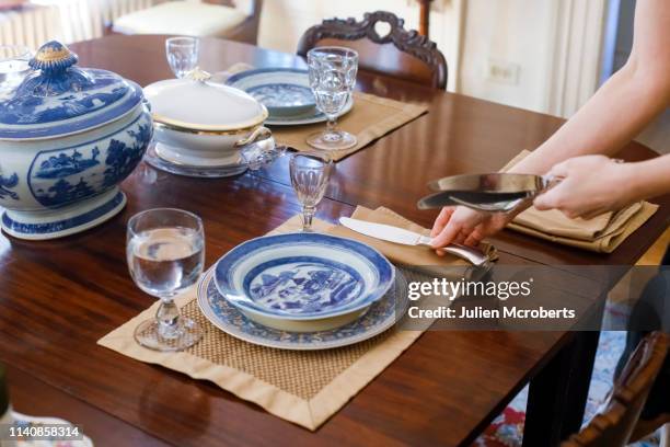 woman's hands setting table with antique tableware - place mat stock pictures, royalty-free photos & images