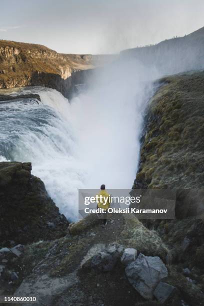 hiker by gullfoss waterfall in iceland - regnkläder bildbanksfoton och bilder