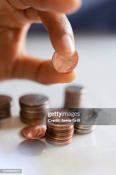hand of woman stacking coins - us coin stock pictures, royalty-free photos & images