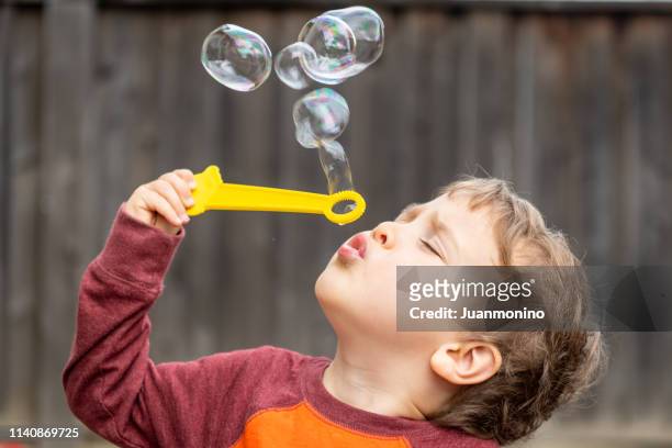three years old child boy blowing bubbles - 2 3 years stock pictures, royalty-free photos & images