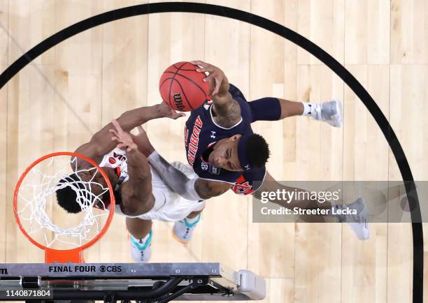 De'Andre Hunter of the Virginia Cavaliers blocks a dunk by Bryce Brown of the Auburn Tigers in the second half during the 2019 NCAA Final Four...