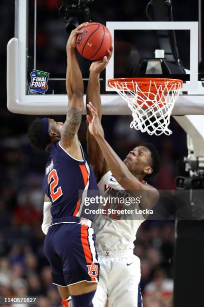 De'Andre Hunter of the Virginia Cavaliers blocks a dunk by Bryce Brown of the Auburn Tigers in the second half during the 2019 NCAA Final Four...