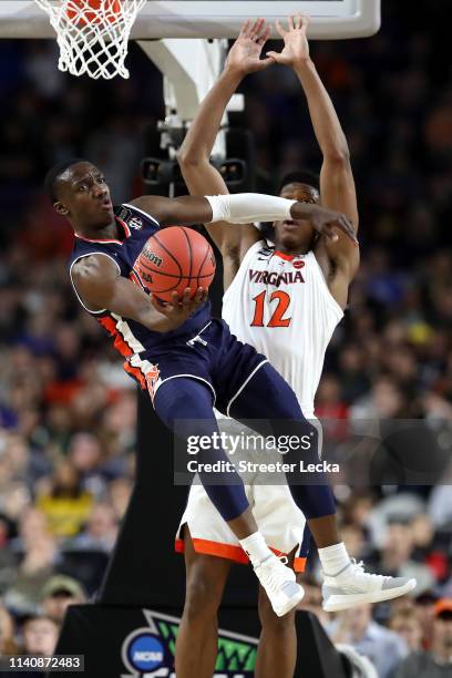 Jared Harper of the Auburn Tigers handles the ball against De'Andre Hunter of the Virginia Cavaliers in the second half during the 2019 NCAA Final...