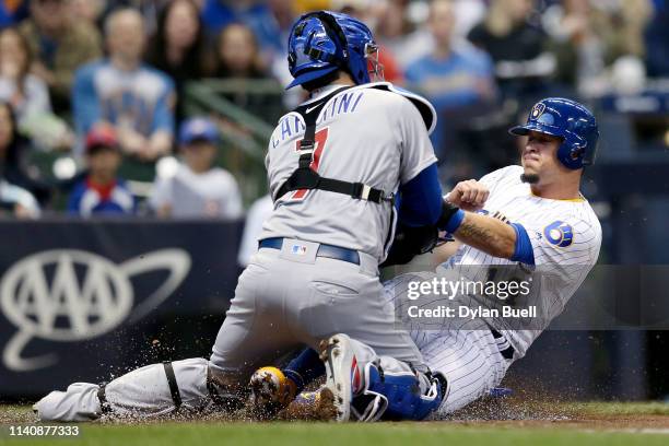 Victor Caratini of the Chicago Cubs tags out Hernan Perez of the Milwaukee Brewers at home plate in the second inning at Miller Park on April 06,...