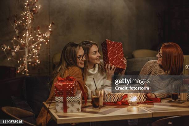 three women enjoying coffee and gifts - new year gifts imagens e fotografias de stock