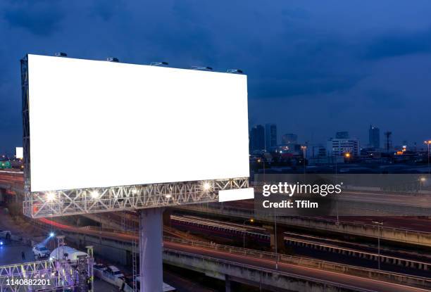 billboard street on light trails for outdoor advertising poster or blank billboard at night time for advertisement. street light. - billboard night photos et images de collection