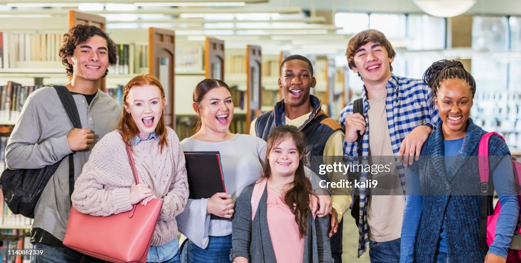 High school students in library, girl with down syndrome