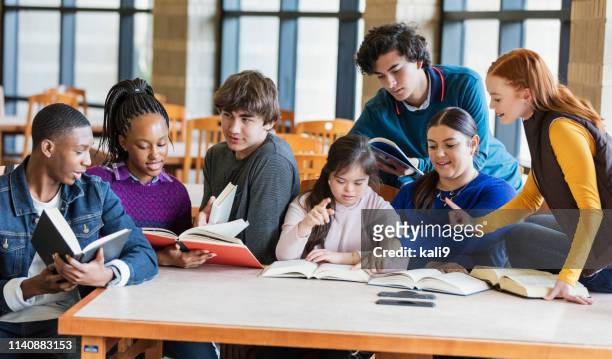 teenage girl with down syndrome and friends studying - book discussion stock pictures, royalty-free photos & images