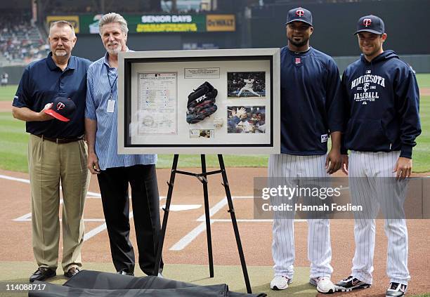 Former pitchers Bert Blyleven and Jack Morris of the Minnesota Twins present Francisco Liriano and catcher Drew Butera of the Minnesota Twins with a...