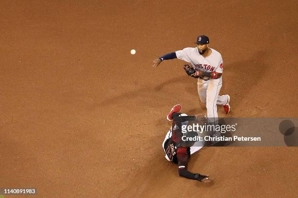 Infielder Eduardo Nunez of the Boston Red Sox throws over the sliding Adam Jones of the Arizona Diamondbacks as he attempts an unsuccessful double...