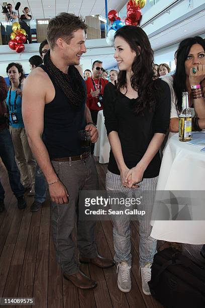 Lee Ryan of the UK band Blue chats with German singer Lena Meyer-Landrut of Germany while sailing on a ship on the Rhine River during the Eurovision...