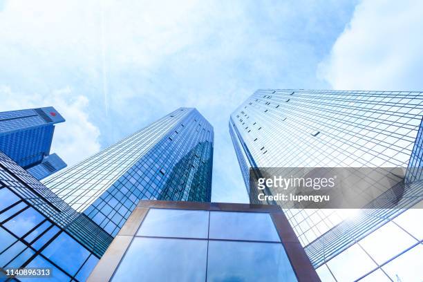 low angle view of skyscrapers - wolkenkratzer stock-fotos und bilder