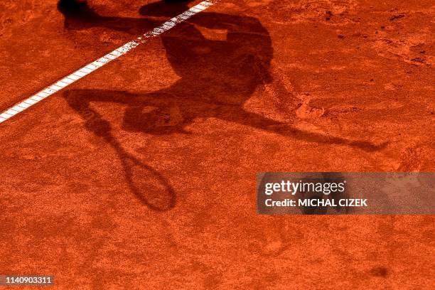 The shadow of Switzerland's Jil Teichmann is seen as she serves to Czech Republic's Barbara Strycova during their semi-final tennis match at the WTA...