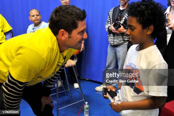 Catcher Francisco Cervelli of the New York Yankees speaks to a child fan during a visit to hospitalized children in honor of Project Sunshine Week at...