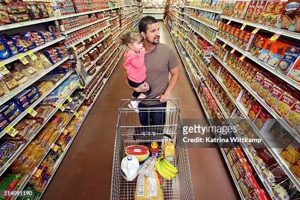 dad and daughter at grocery store. - iowa family stock pictures, royalty-free photos & images