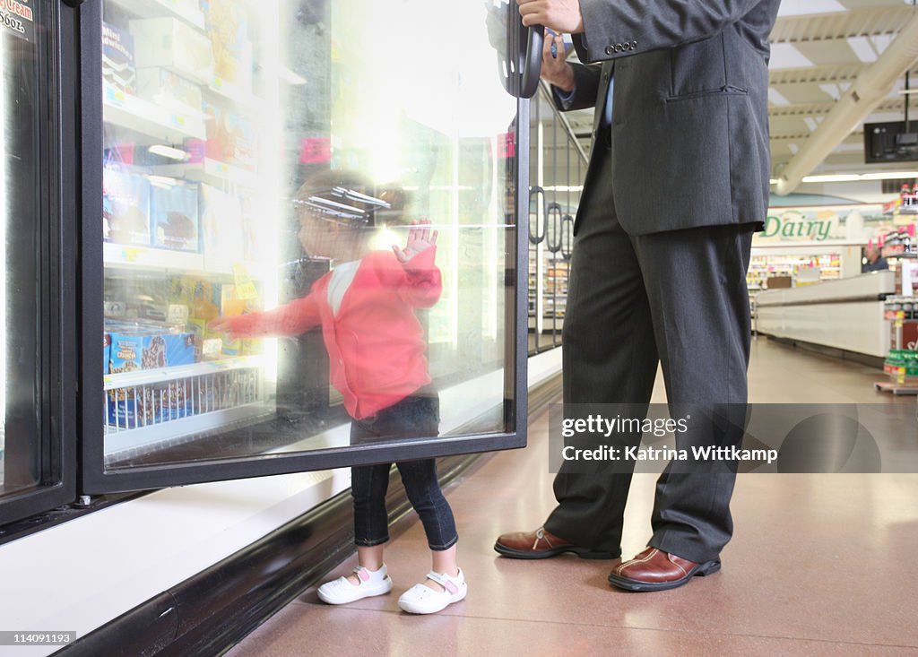 Dad and daughter at grocery store.