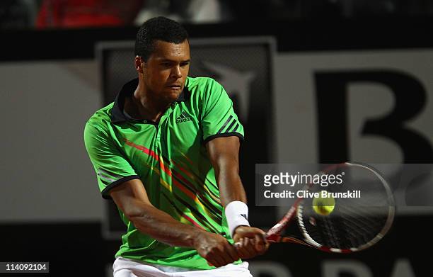 Jo-Wilfried Tsonga of France plays a backhand during his second round match against Roger Federer of Switzerland during day four of the...