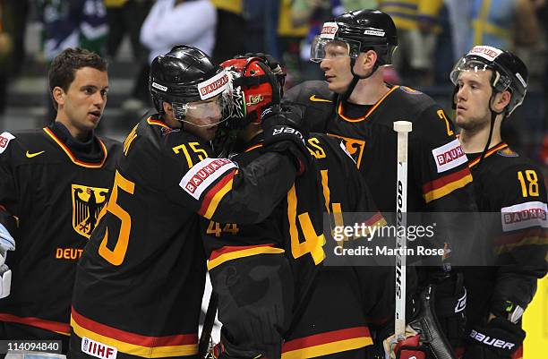 Marcus Kink of Germany comforts team mate Dennis Endras after the IIHF World Championship quarter final match between Sweden and Germany at Orange...