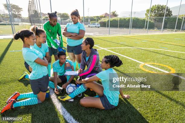 girls soccer team listening to their female coach - huddle sport girls stock pictures, royalty-free photos & images