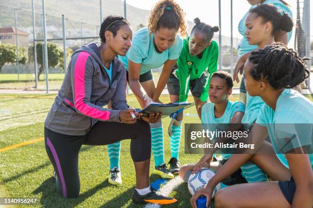 girls soccer team listening to their female coach - soccer team coach stock pictures, royalty-free photos & images