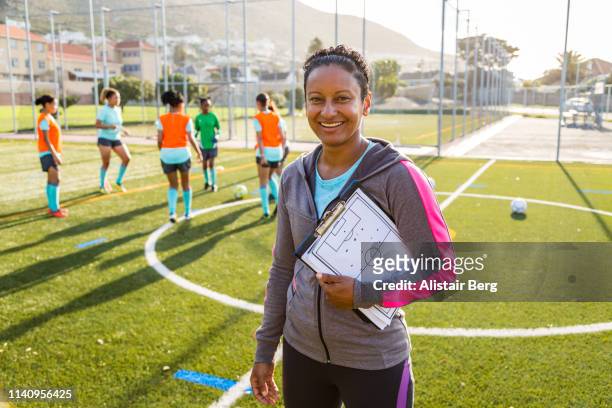 portrait of female coach at soccer team practice - coach stock pictures, royalty-free photos & images