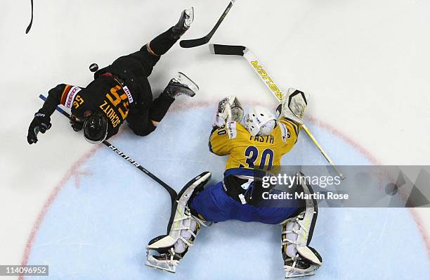 Viktor Fasth , goaltender of Sweden makes a save on Felix Schuetz of Germany during the IIHF World Championship quarter final match between Sweden...