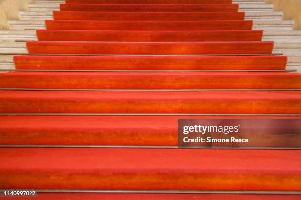 ancient stairs with red carpet in an old building in italy - red carpet hospitality gala fotografías e imágenes de stock