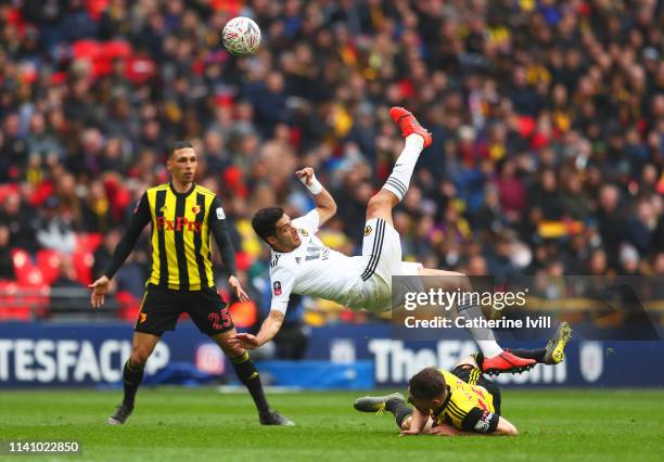 Raul Jimenez of Wolverhampton Wanderers battles with Craig Cathcart and Jose Holebas of Watford during the FA Cup Semi Final match between Watford...