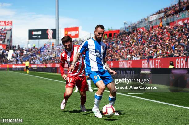 Sergi Darder of RCD Espanyol is challenged by Patrick Roberts of Girona during the La Liga match between Girona FC and RCD Espanyol at Montilivi...