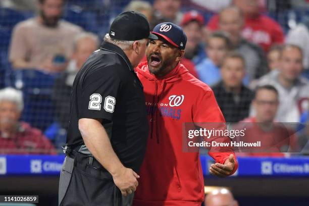 Manager Dave Martinez of the Washington Nationals argues with umpire Bill Miller in the fourth inning during the game against the Philadelphia...