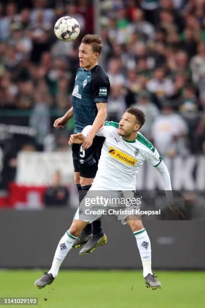 Ludwig Augustinsson of Werder Bremen challenges for the ball with Fabian Johnson of Borussia Monchengladbach during the Bundesliga match between...