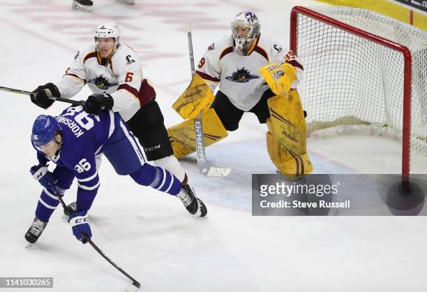 Cleveland Monsters defenseman Ryan Collins tries to clear Toronto Marlies forward Egor Korshkov from in front of Cleveland Monsters goaltender Brad...