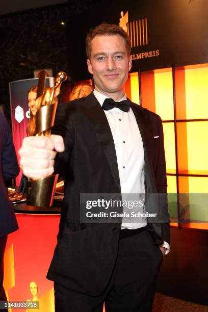 Alexander Fehling, winner of Best Supporting Actor, poses with award during the Lola - German Film Award party at Palais am Funkturm on May 3, 2019...