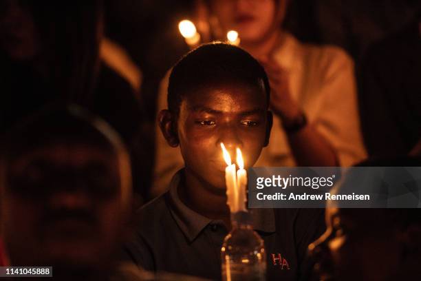 Boy holds a candle during a commemoration ceremony of the 1994 genocide on April 07, 2019 at Amahoro Stadium in Kigali, Rwanda. The country is...