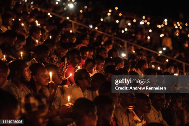 People hold candles during a commemoration ceremony of the 1994 genocide on April 07, 2019 at Amahoro Stadium in Kigali, Rwanda. The country is...