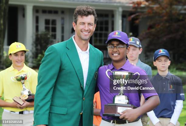 Boys 10-11 group overall winner Sahish Reddy poses with his trophy and Adam Scott of Australia during the Drive, Chip and Putt Championship at...