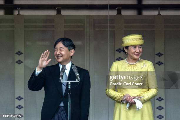Emperor Naruhito of Japan waves to members of the public as his wife, Empress Masako, stands beside him on the balcony of the Imperial Palace on May...