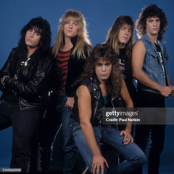 Portrait of American Rock group Shok Paris as they pose against a blue background in a photo studio, Cleveland, Ohio, January 11, 1989. Pictured are,...