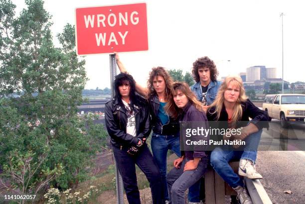 Portrait of American Rock group Shok Paris as they pose in front of a 'Wrong Way' street sign, Cleveland, Ohio, September 15, 1987. Pictured are,...