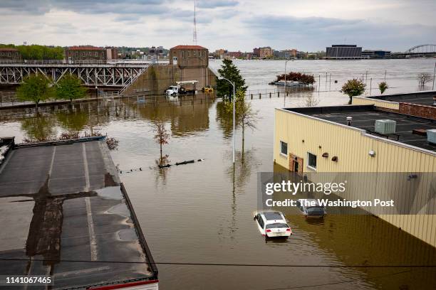 Flood waters surround area businesses near the main breach in the Mississippi River in Davenport, Iowa on Friday, May 3, 2018.