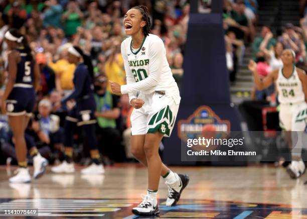 Juicy Landrum of the Baylor Lady Bears celebrates the play against the Notre Dame Fighting Irish during the first quarter in the championship game of...