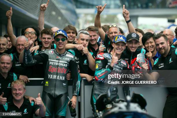 Petronas Yamaha SRT's French rider Fabio Quartararo celebrates after earning the pole position for tomorrow's race beside second placed, teammate...