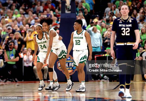 Chloe Jackson, DiDi Richards and Moon Ursin of the Baylor Lady Bears celebrate their teams lead in the final seconds of their teams win as Jessica...